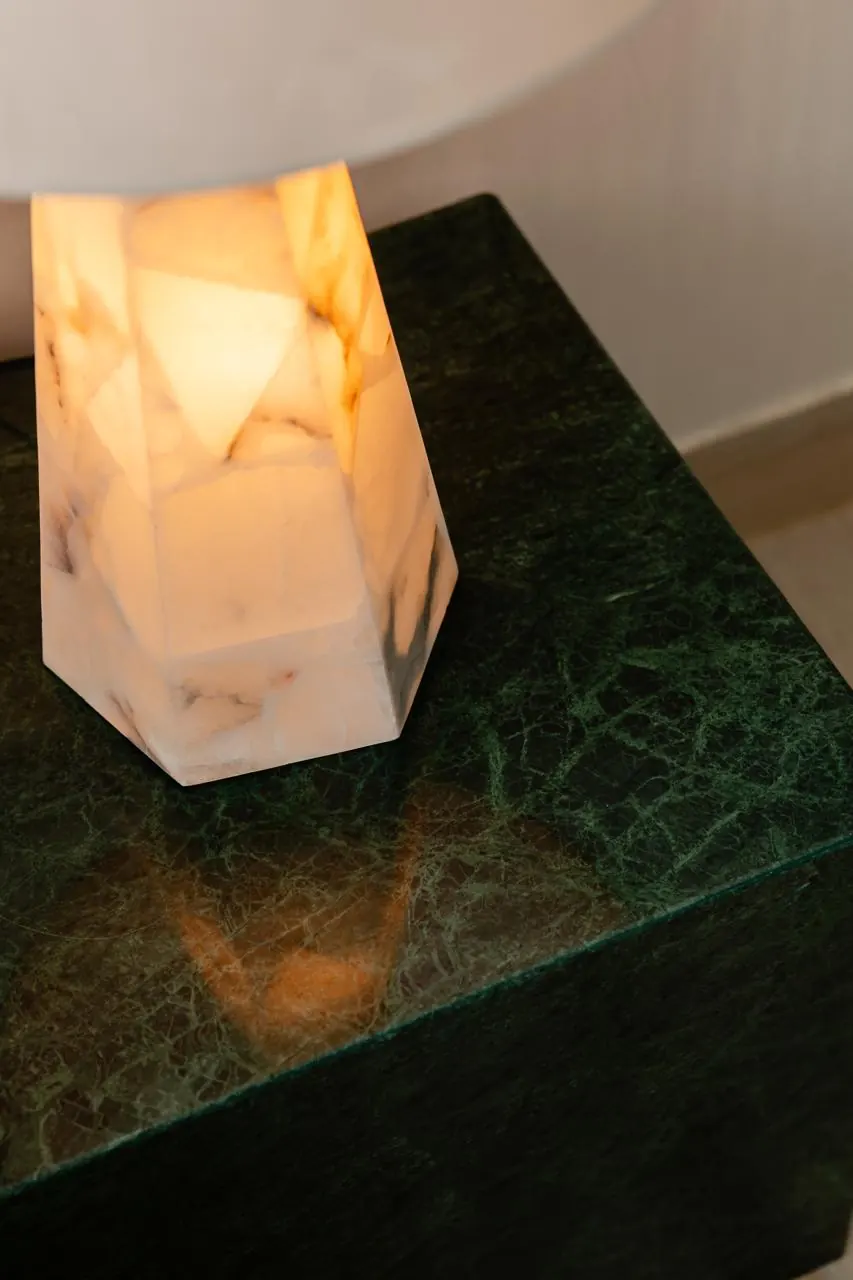 Alabaster lamp on green marble bedside table